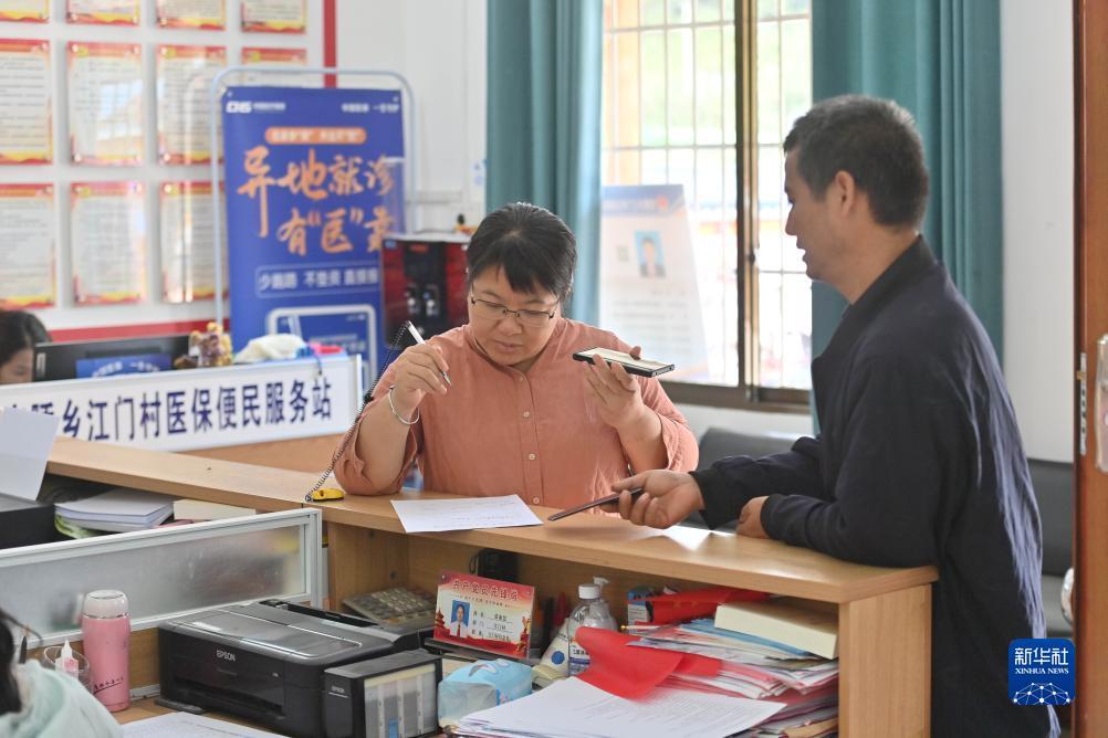 　　杨宁（左）在办公室为村民办事（10月8日摄）